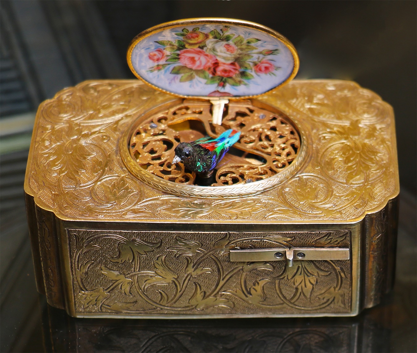 A gilt metal and enamel musical bird box
